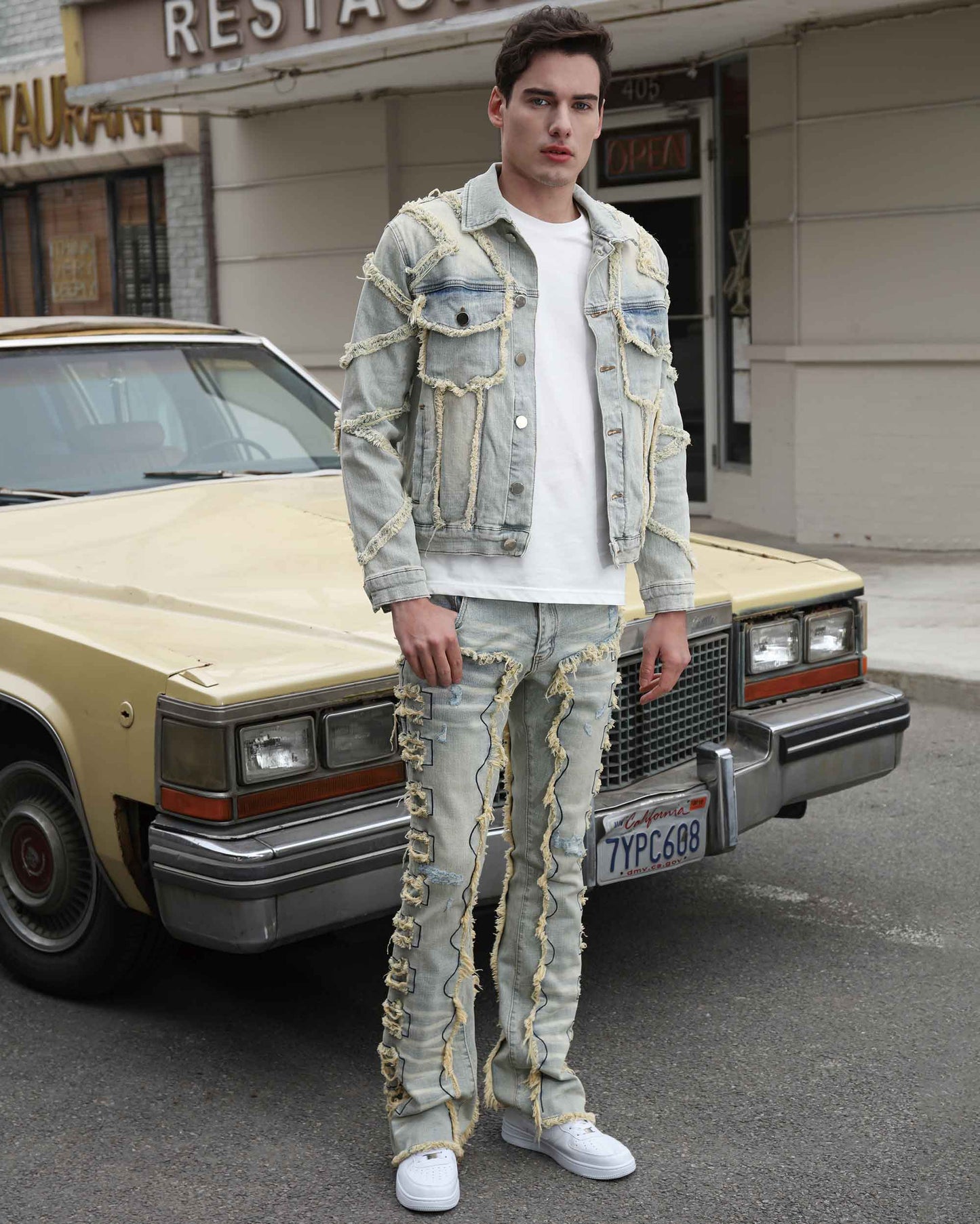 Logeqi vintage blue stacked jeans with unique seam detailing worn by a male model
