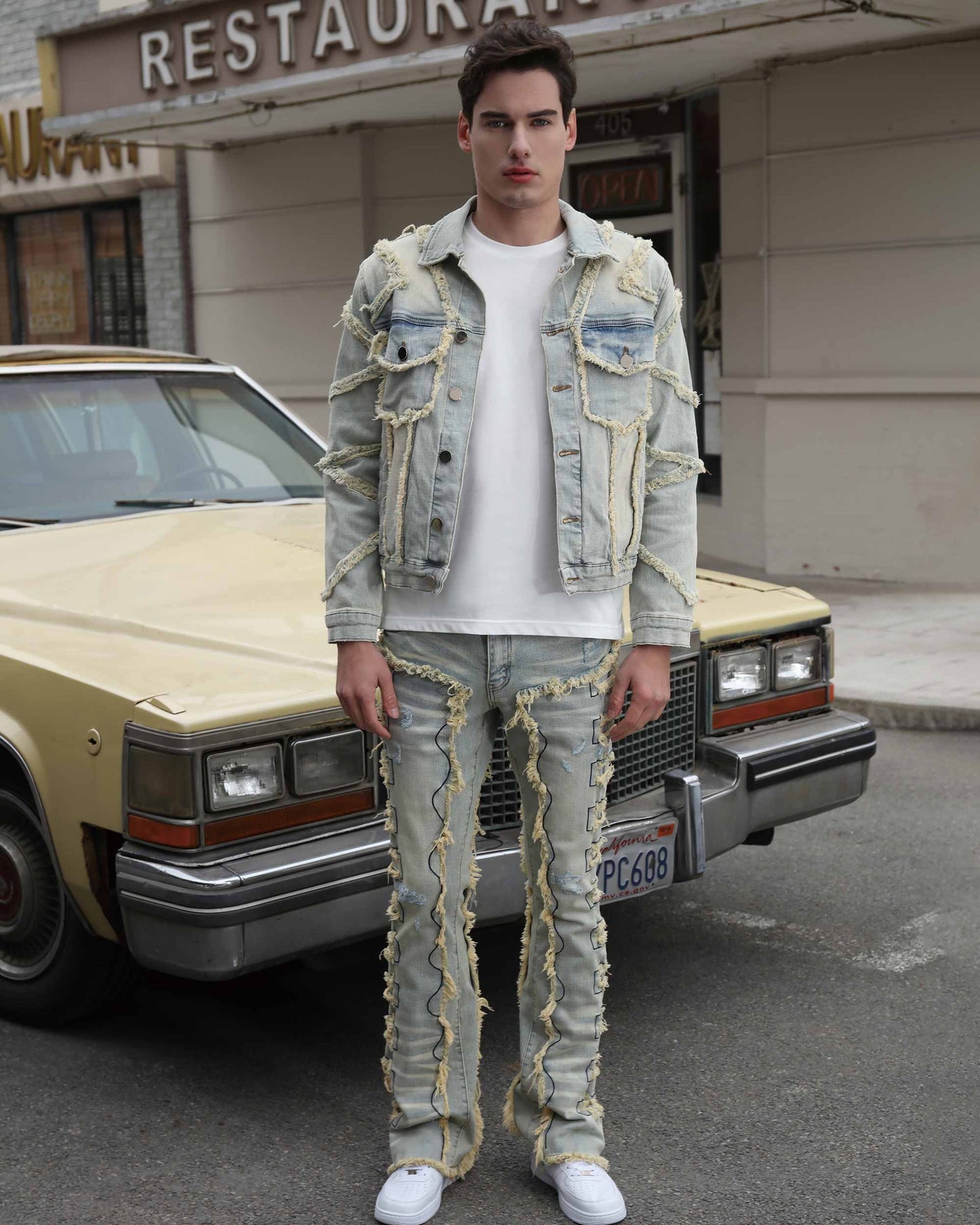 Logeqi vintage blue stacked jeans with distinctive ruffled seams worn by male model