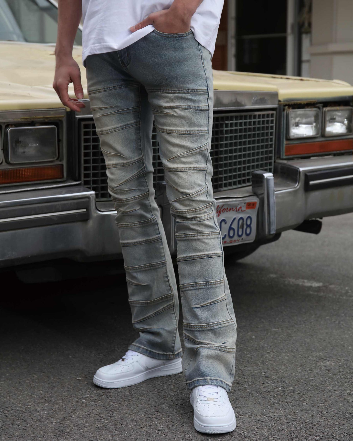 Men wearing Logeqi vintage distressed blue jeans with ribbed knee details and white sneakers