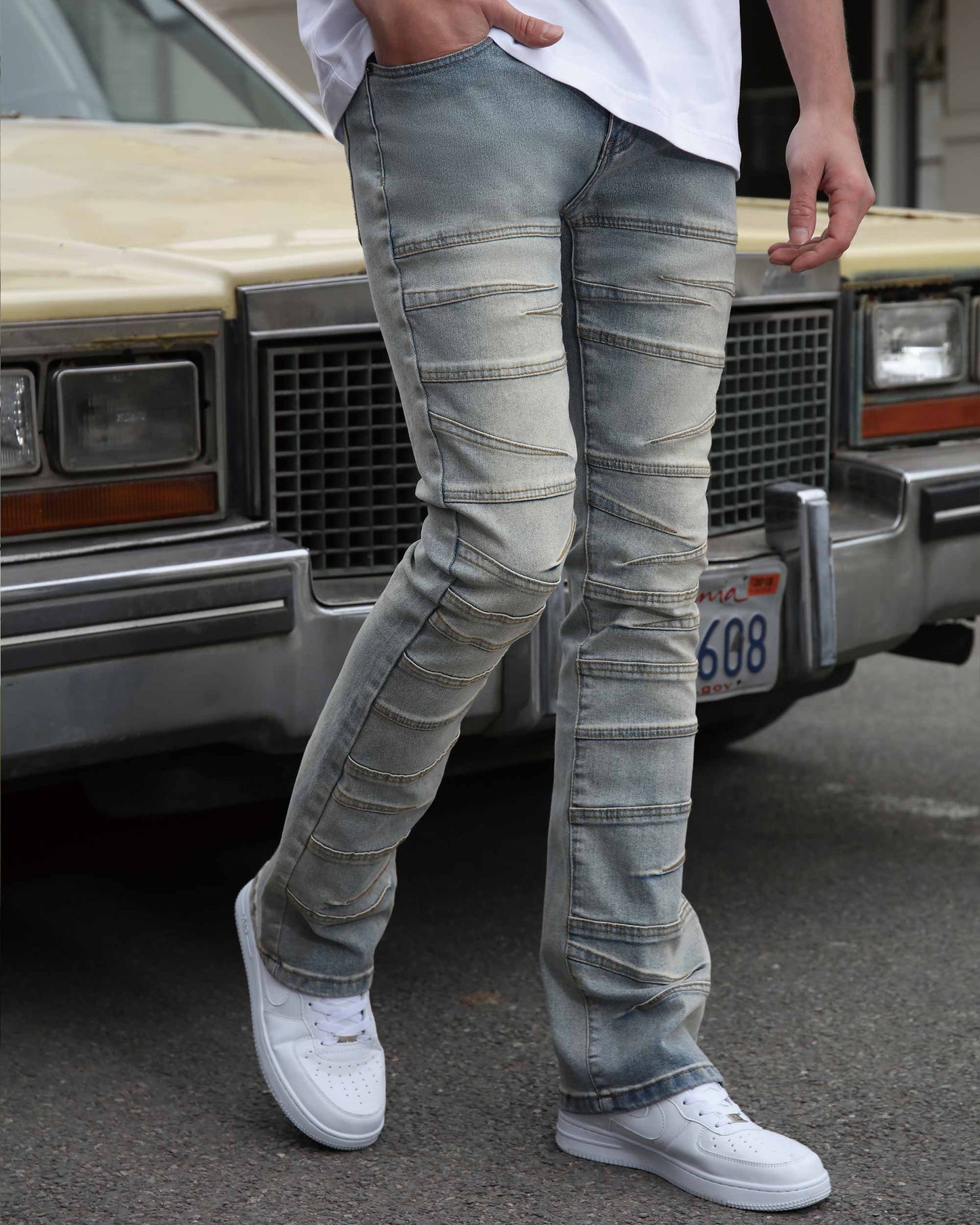 Man wearing Logeqi vintage distressed blue jeans with ribbed panels and white sneakers