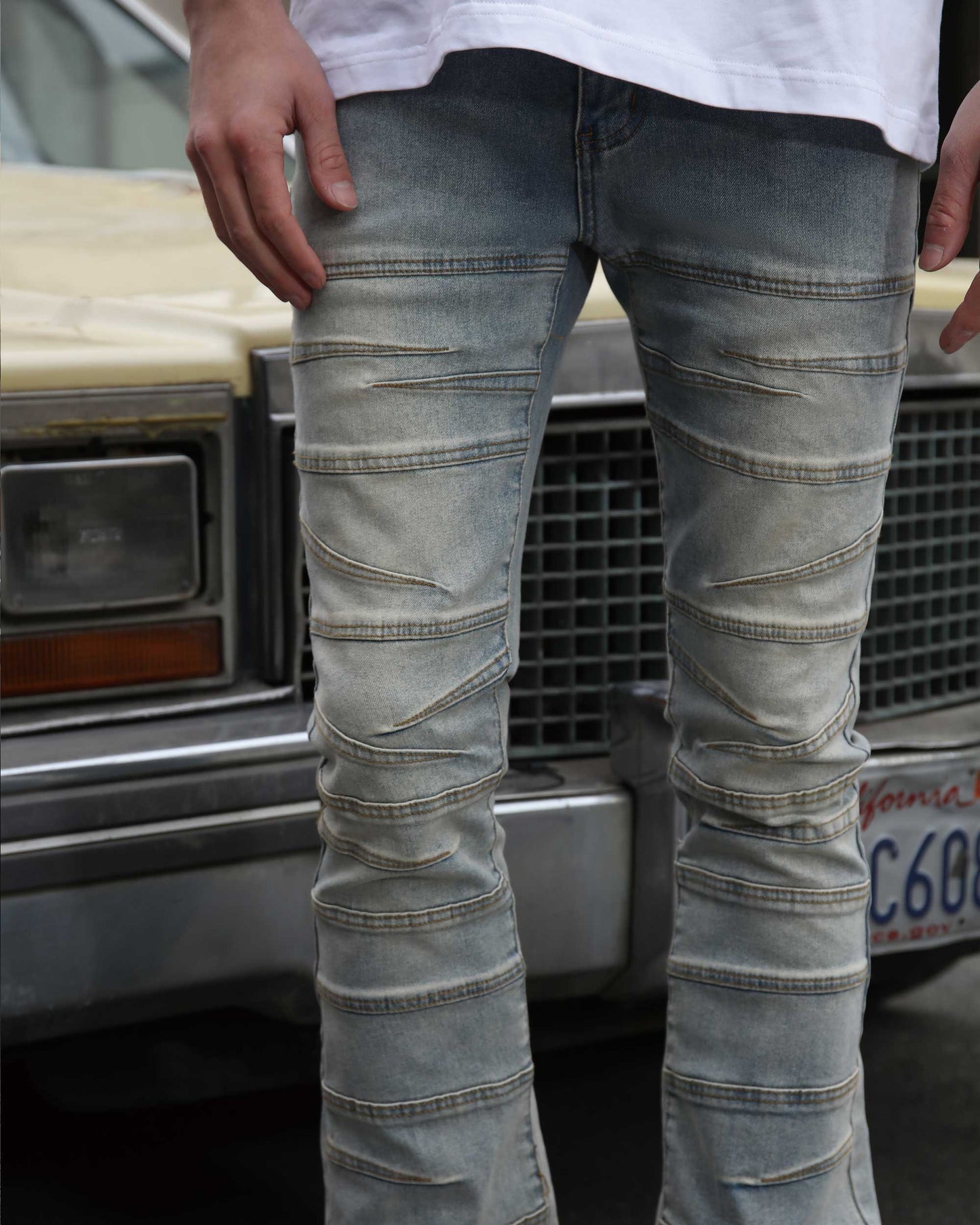Logeqi vintage distressed blue jeans with detailed stitching worn by person standing by a vintage car