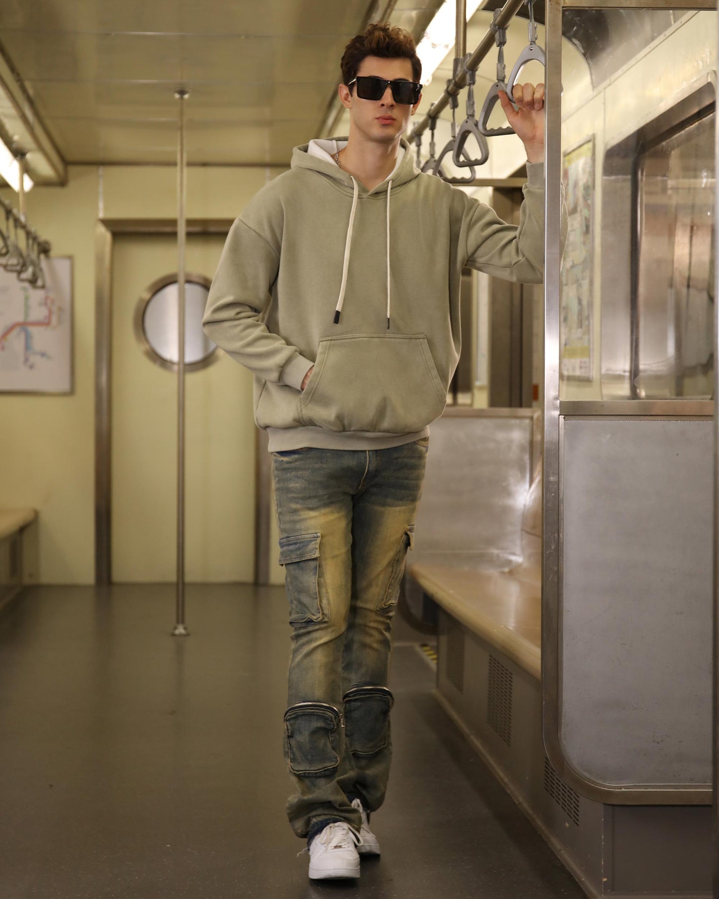 Logeqi vintage distressed cargo jeans modeled by a man on a subway train