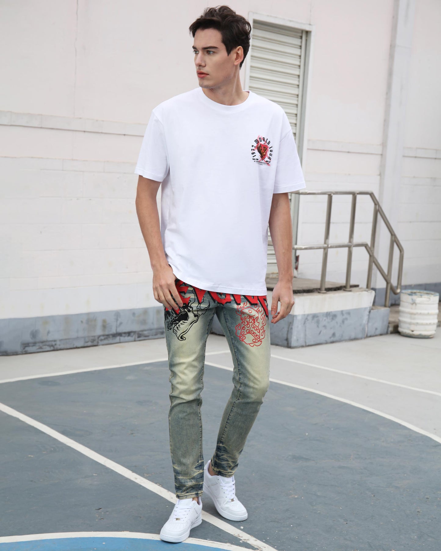 Logeqi vintage graffiti jeans worn by man styled with white graphic t-shirt and white sneakers