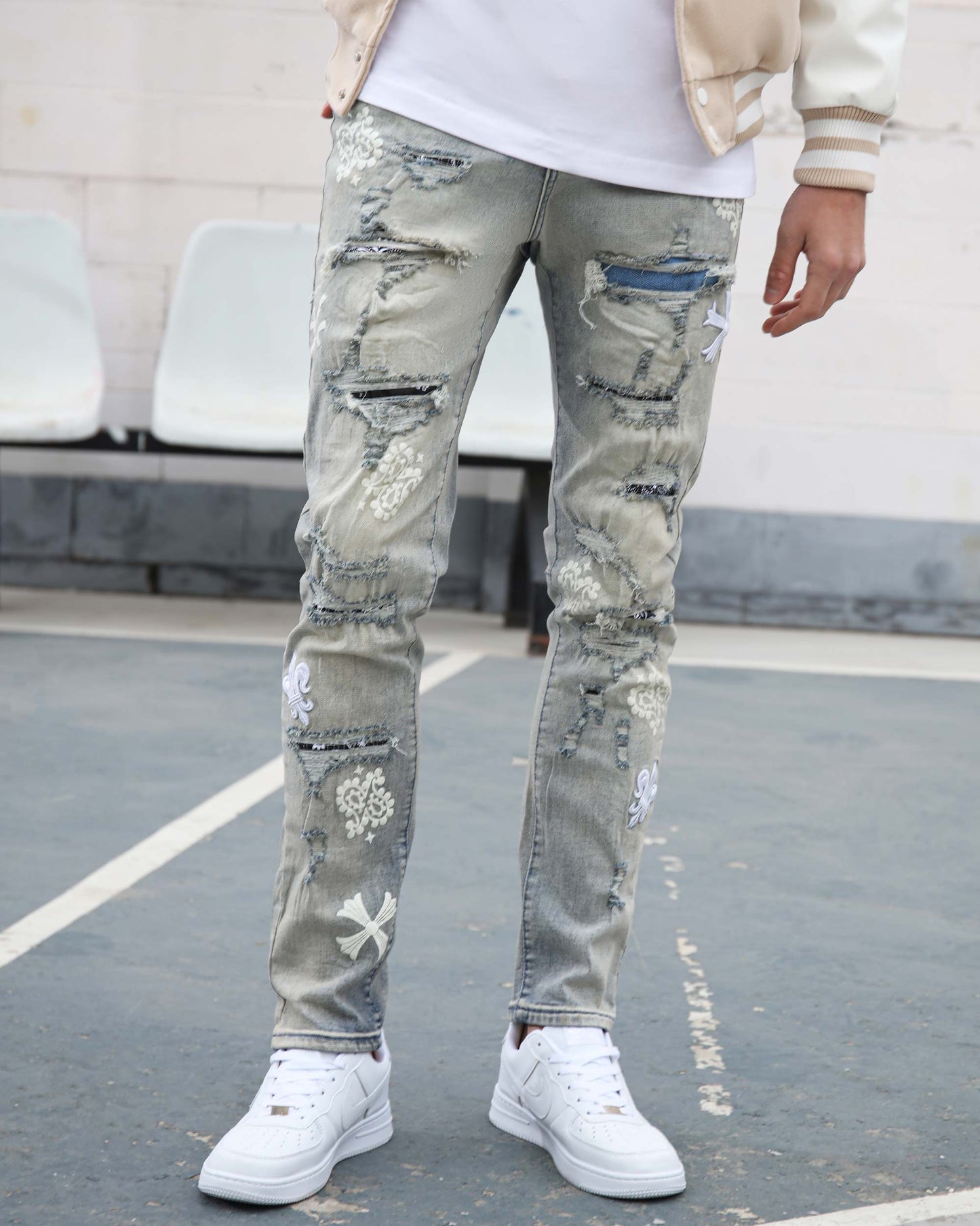Logeqi vintage trendsetter denim jeans with distressed and embroidered detailing paired with white sneakers
