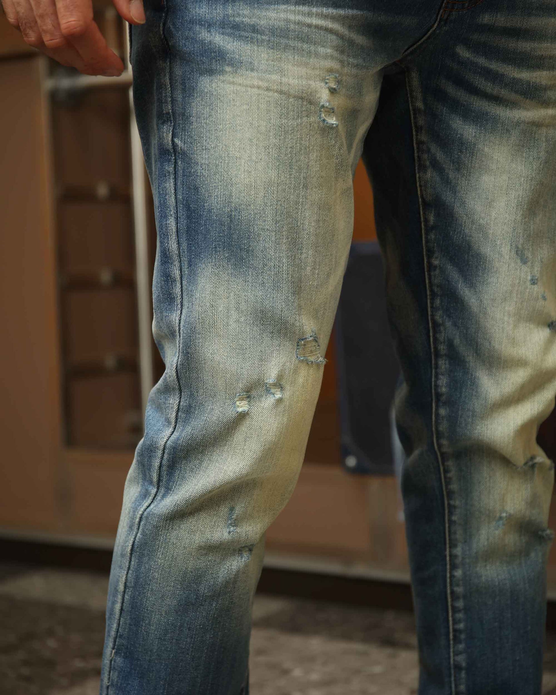 Logeqi whiskered distressed jeans featuring a trendy faded design and stylish rips for a modern look