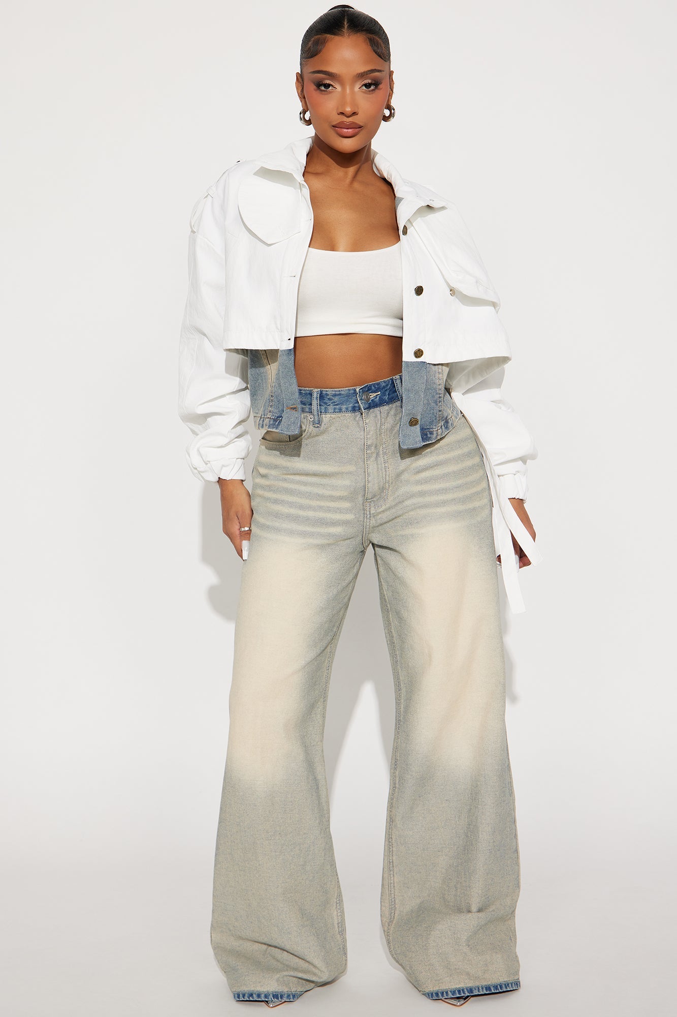 Fashion Nova white cropped trench coat styled with a matching top and light denim pants