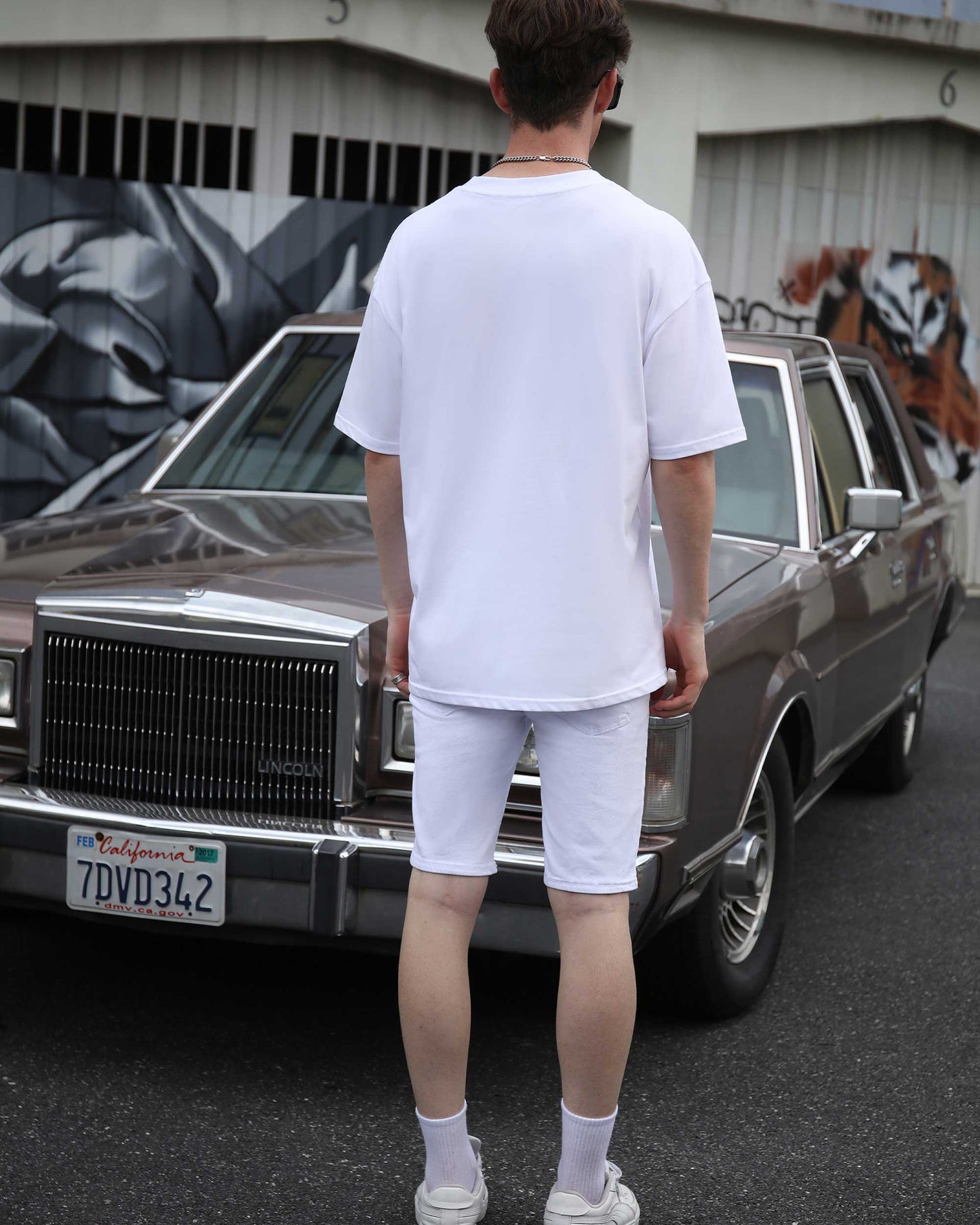 Logeqi White Ripped Denim Shorts styled with a white oversized tee for a trendy street look
