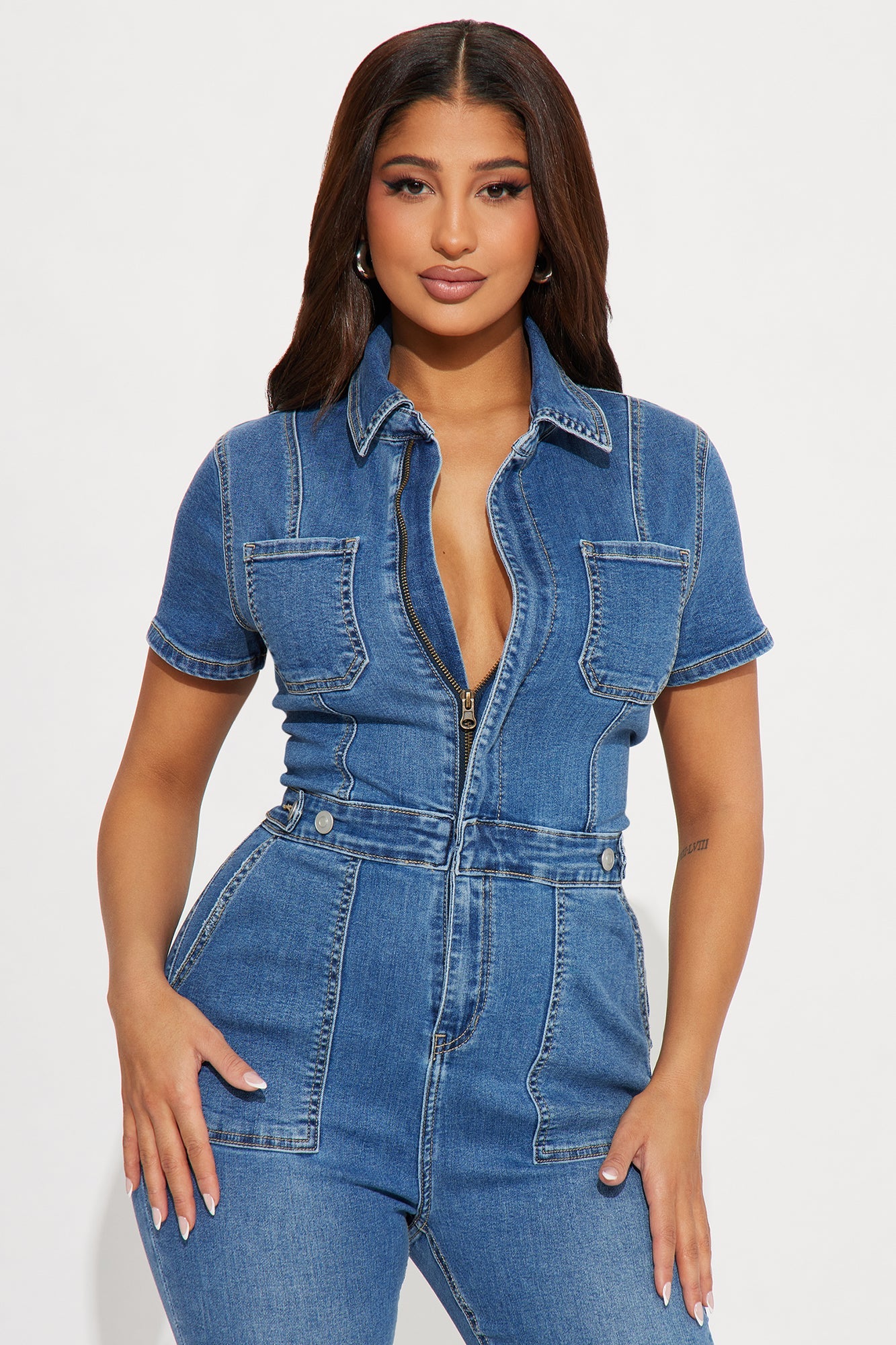 Fashion Nova women's denim jumpsuit medium wash featuring a fitted design and zip front closure