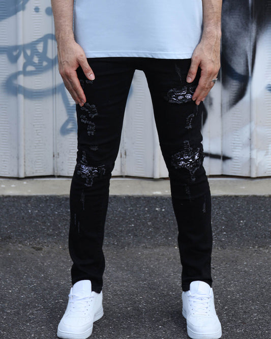 https://cdn.shopify.com/s/files/1/0654/2822/6294/files/LOGEQI_Hip_Hop_Black_Ripped_Jeans_with_Cashew_Flower_Patch_12.jpg?v=1725010779