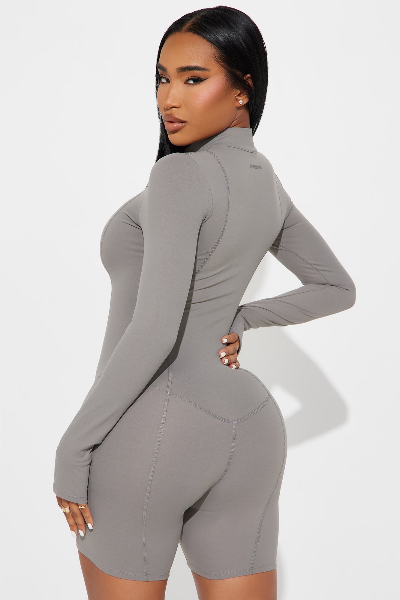 Fashion Nova active romper for women in gray with long sleeves and fitted design