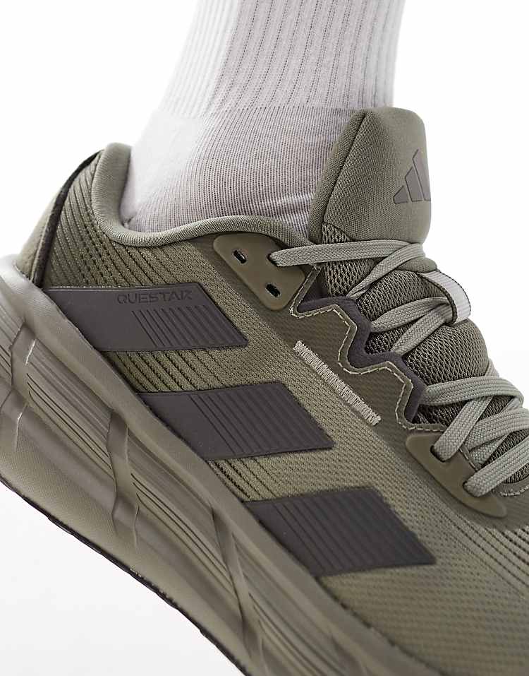 Close-up of adidas Questar 3 olive green sneakers showcasing breathable mesh and stylish design