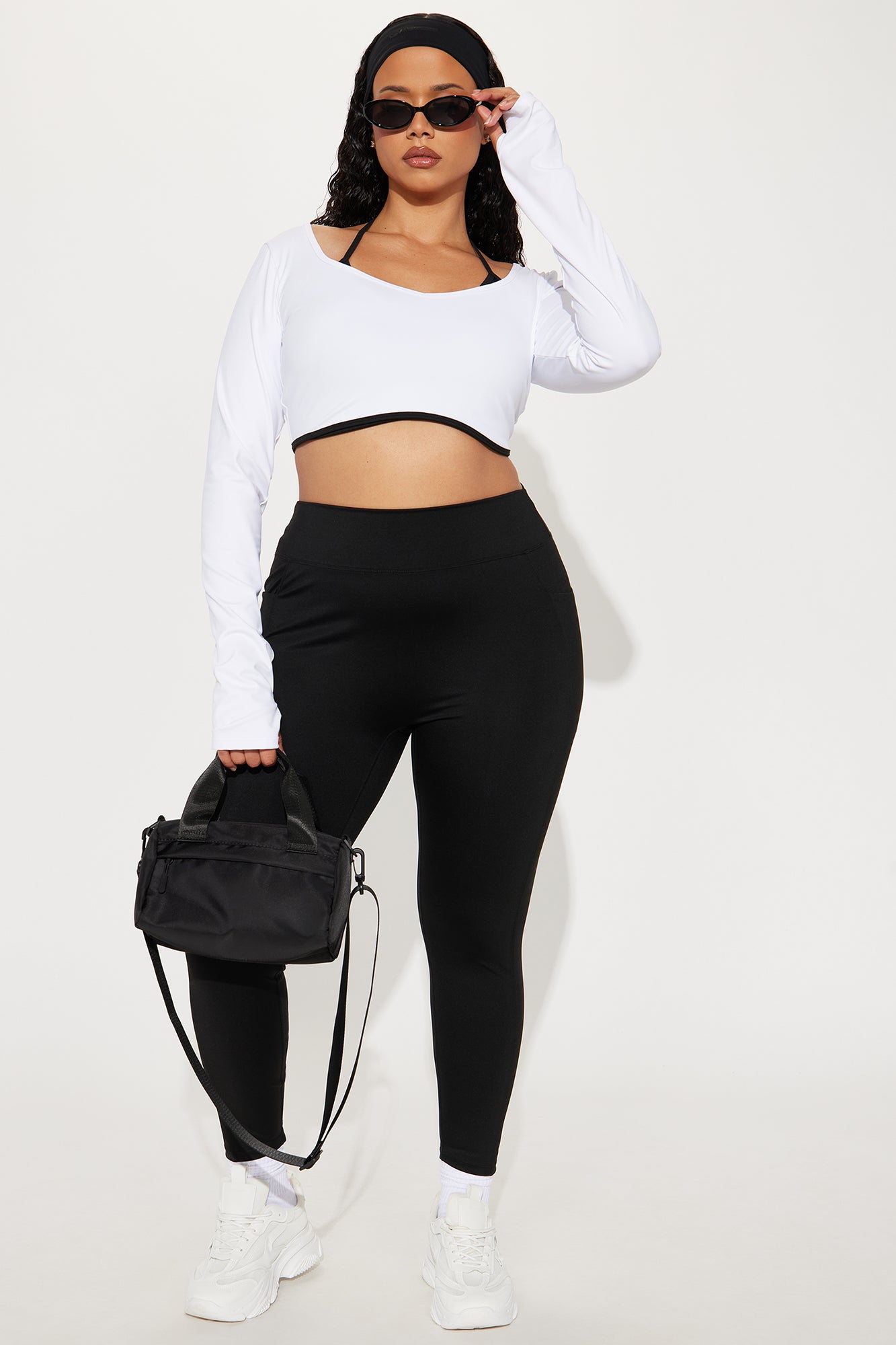 Fashion Nova Black Active Leggings for Women, paired with a white crop top and stylish accessories