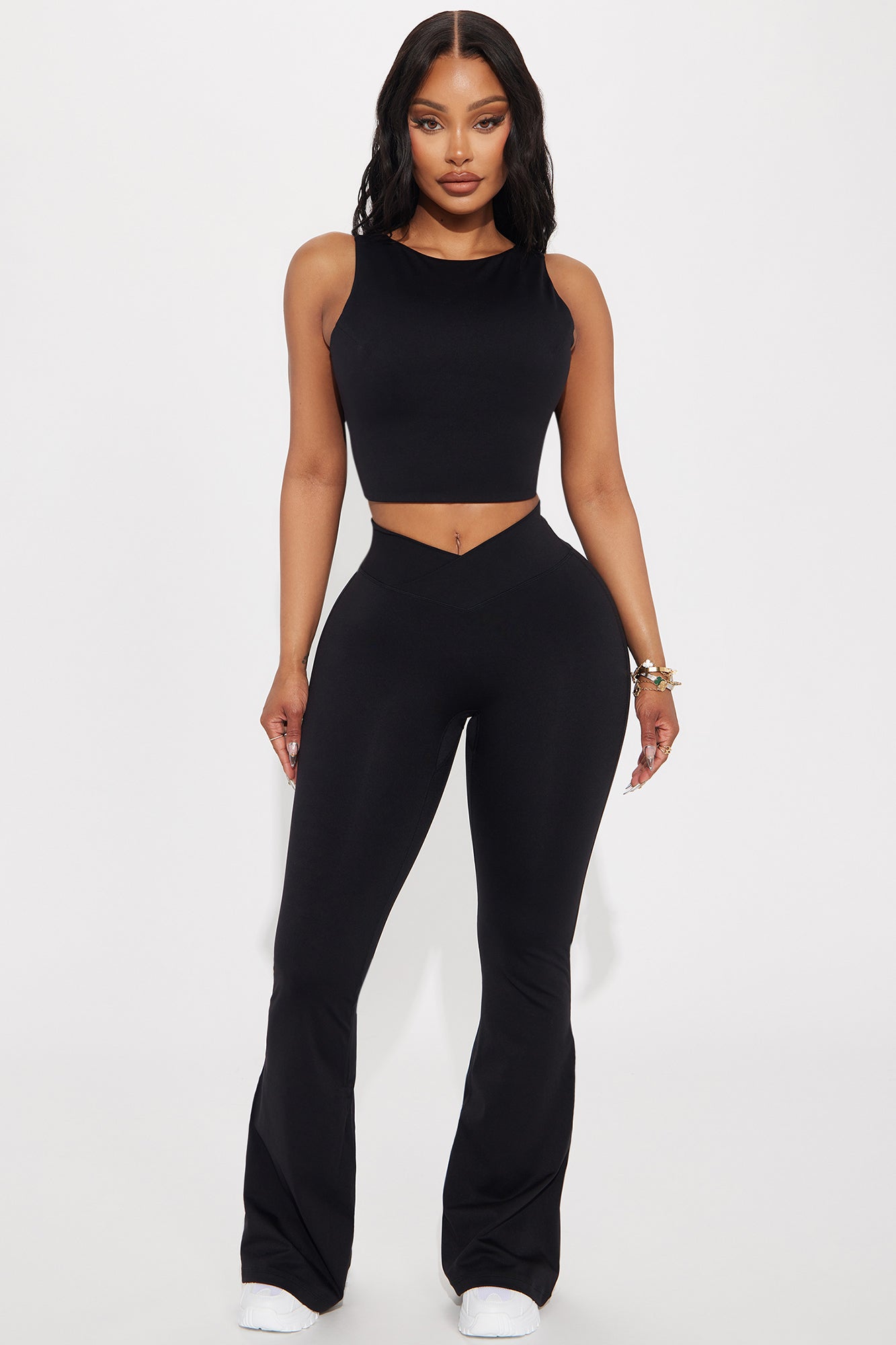 Model wearing black active yoga pants and a matching crop top for stylish workout looks