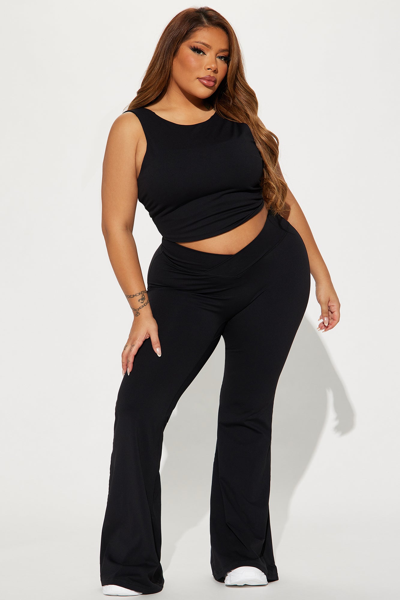 Model wearing black active yoga pants and matching crop top for fitness and stylish workouts