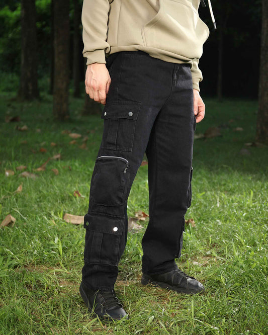 Logeqi black cargo pocket zip jeans with multiple pockets worn outdoors with green grass background