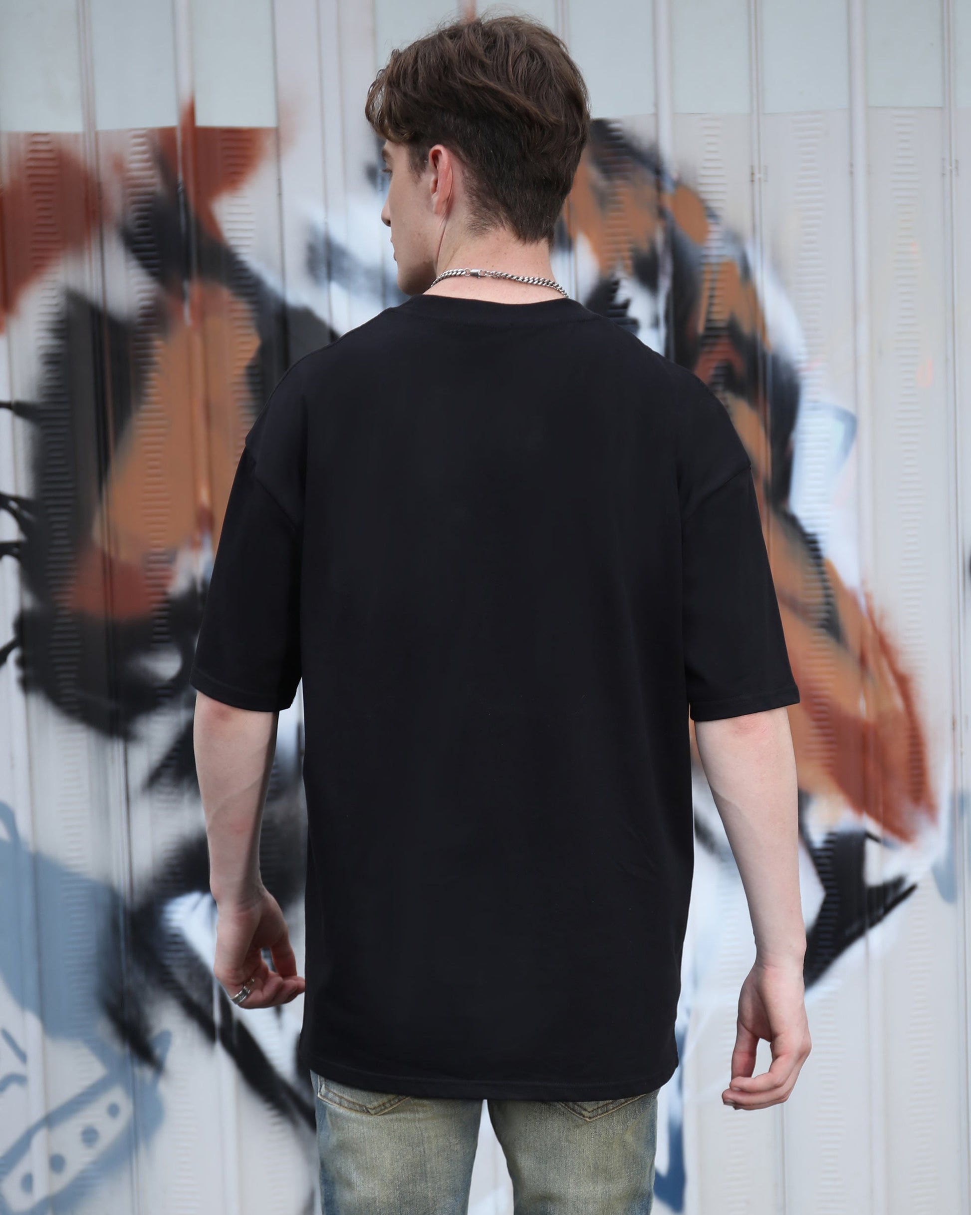 Back view of black cotton t-shirt by Logeqi, featuring an oversized fit and comfortable material