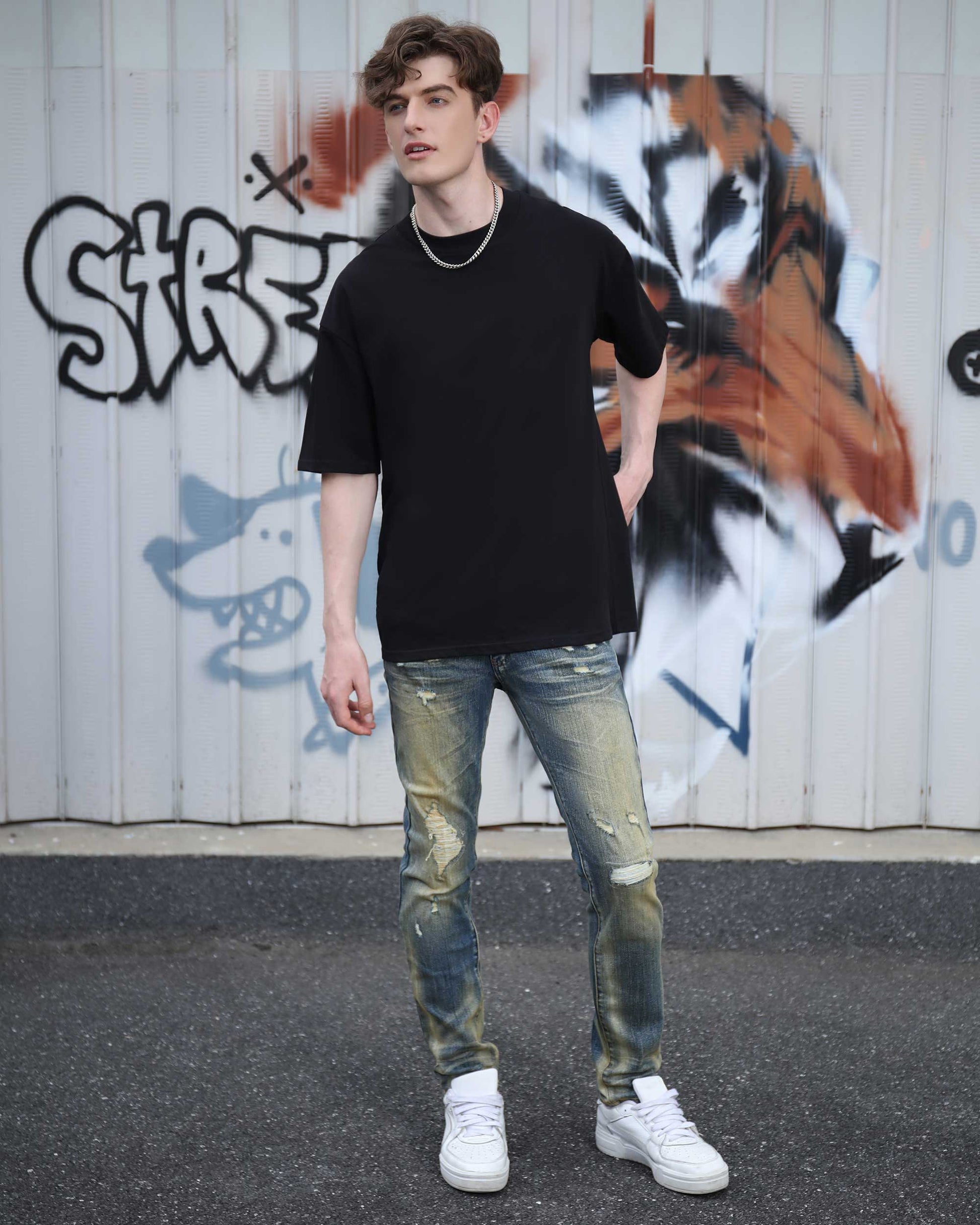 Logeqi black cotton t-shirt styled with distressed jeans for a trendy streetwear look