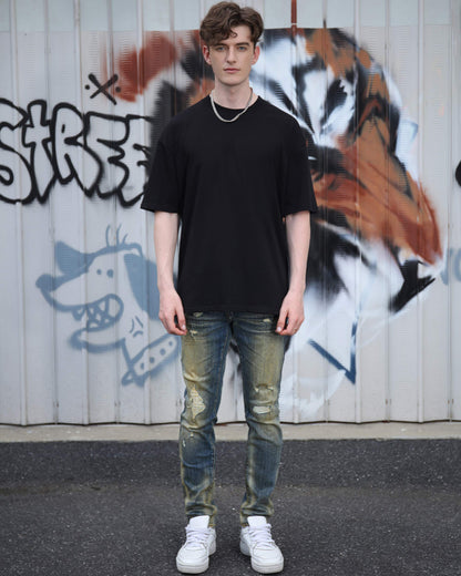 Logeqi black cotton t-shirt featuring an oversized fit paired with distressed jeans