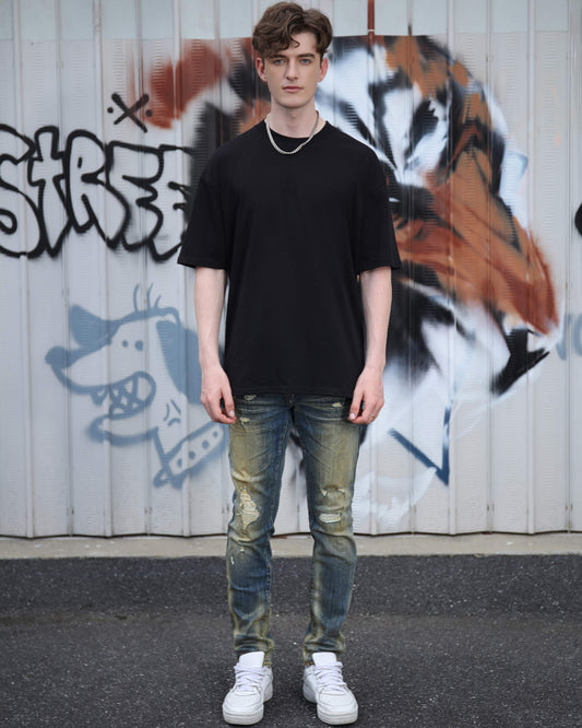 Logeqi black cotton t-shirt featuring an oversized fit paired with distressed jeans