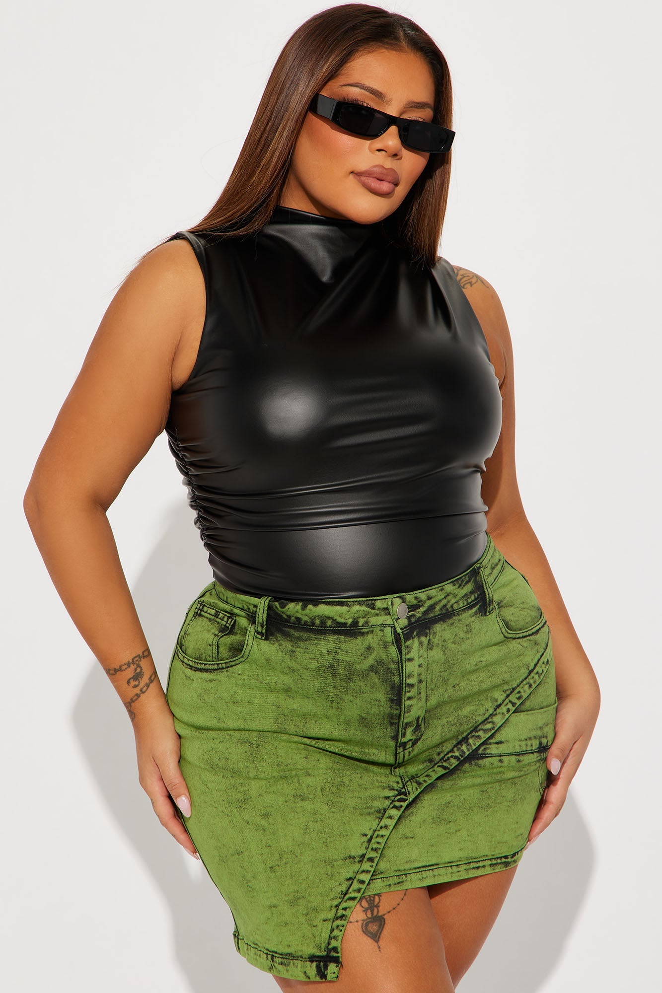 Fashion Nova black faux leather bodysuit styled with a green denim skirt for a trendy outfit