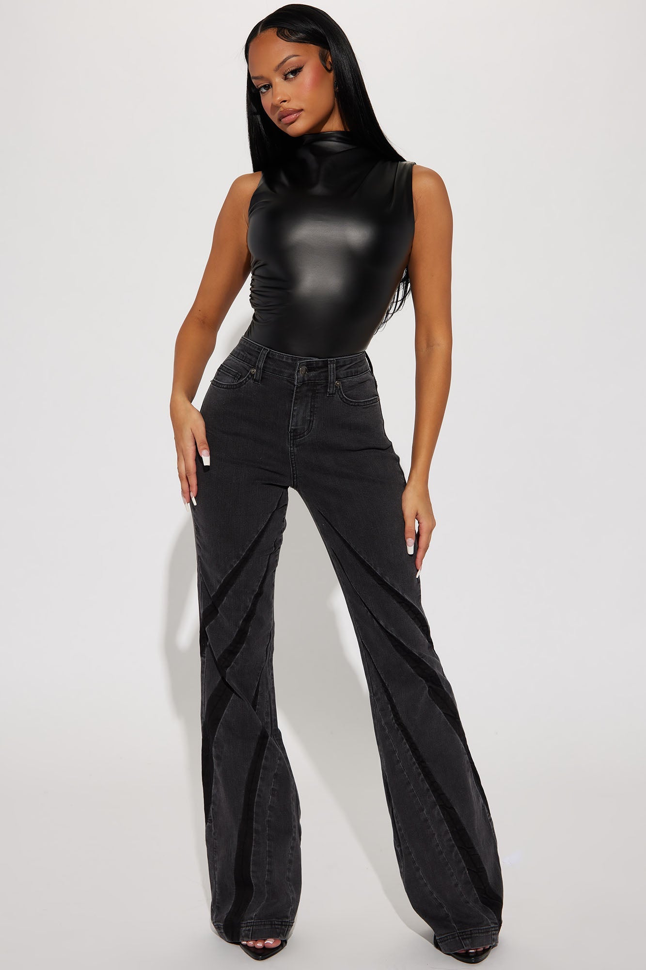 Fashion Nova black faux leather bodysuit paired with high-waisted flared jeans for a stylish look