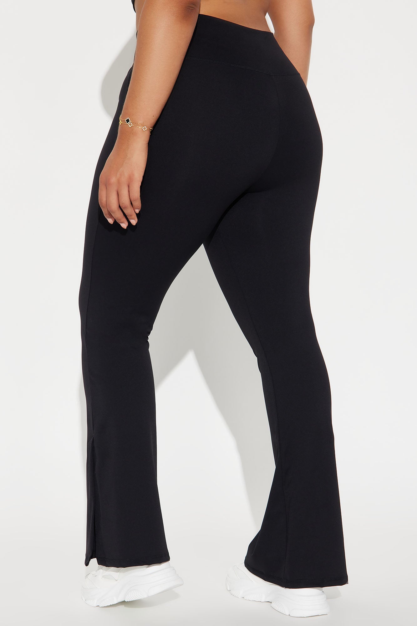 Back view of women wearing black flare yoga pants for women with a comfortable fit and stylish design