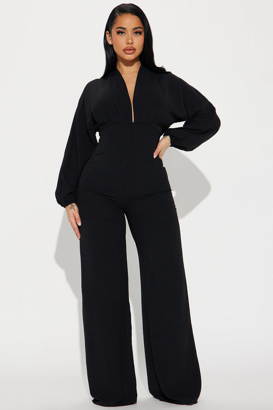 Elegant black jumpsuit for women with a deep V-neck and wide-leg pants from Fashion Nova