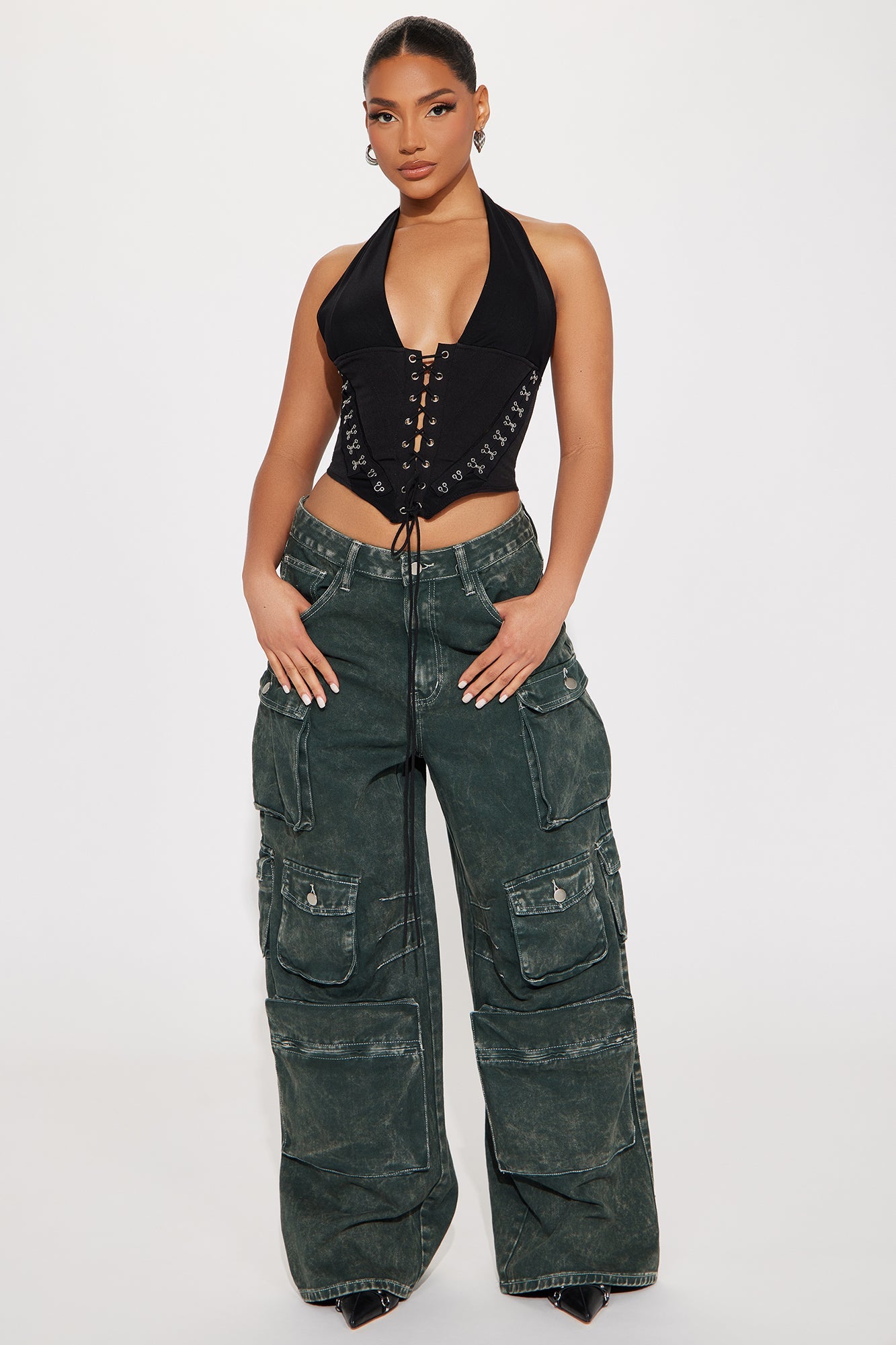 Model wearing a black lace up halter top paired with stylish cargo pants for a chic look