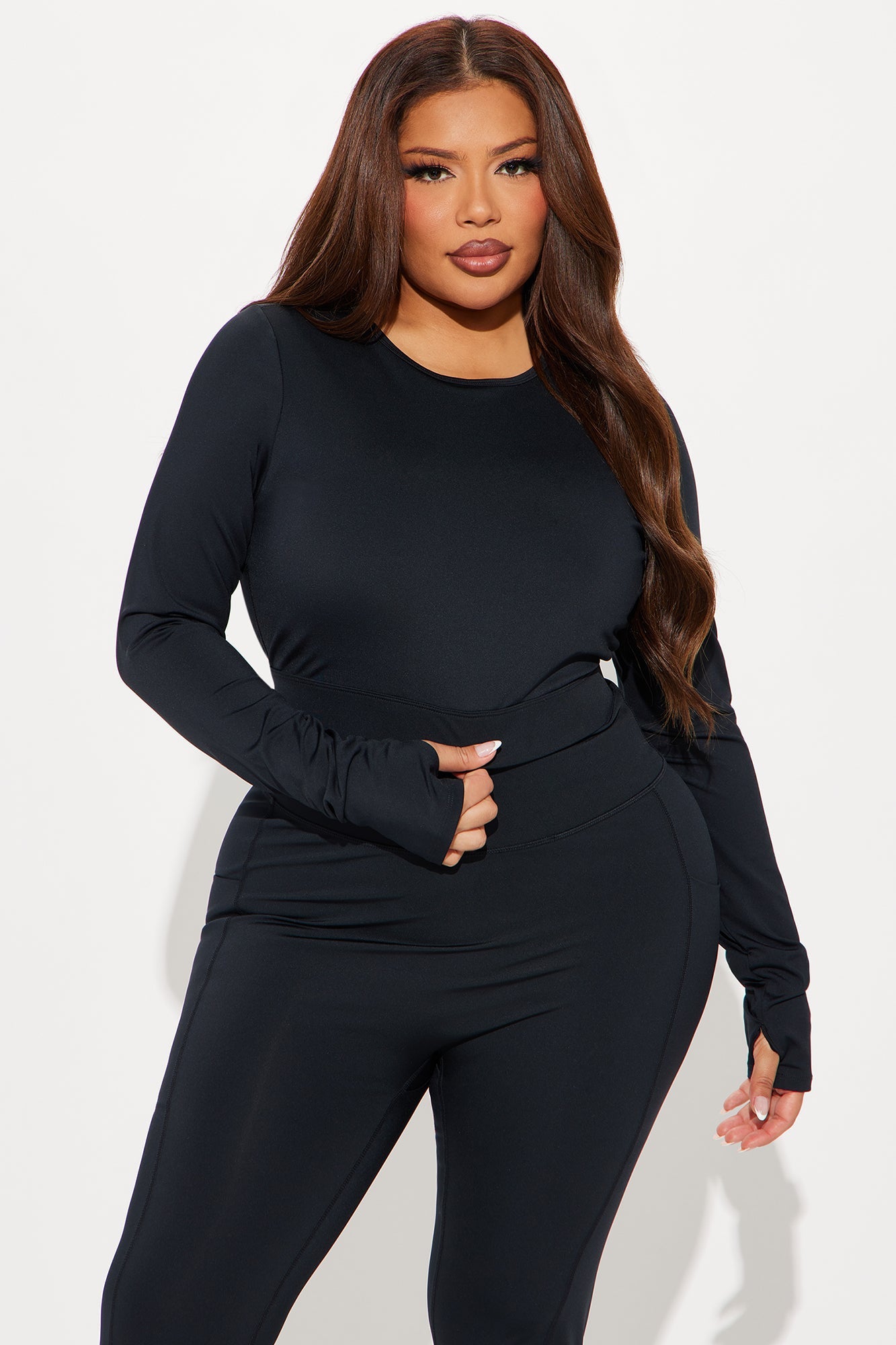 Model wearing a black open back active top from Fashion Nova, perfect for workouts and casual outings