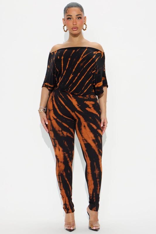 Fashion Nova black tie dye jumpsuit with off-shoulder design and fitted legs