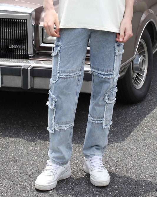 Blue jeans with fringed detailing by Logeqi worn with white sneakers and a white top