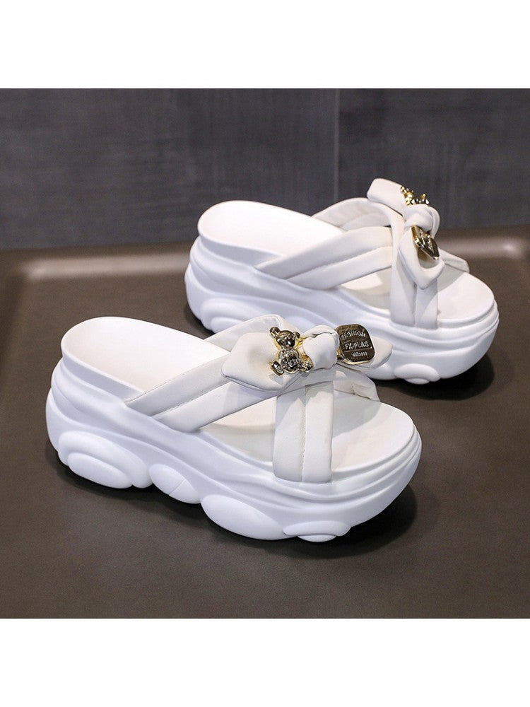 White bow platform slippers for women with thick cushioned soles and decorative metal accents