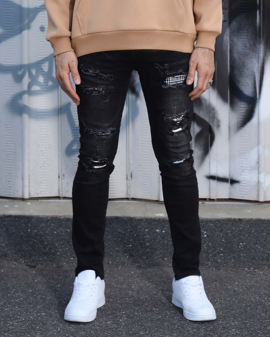Logeqi black ripped jeans with plaid patch worn with beige hoodie and white sneakers