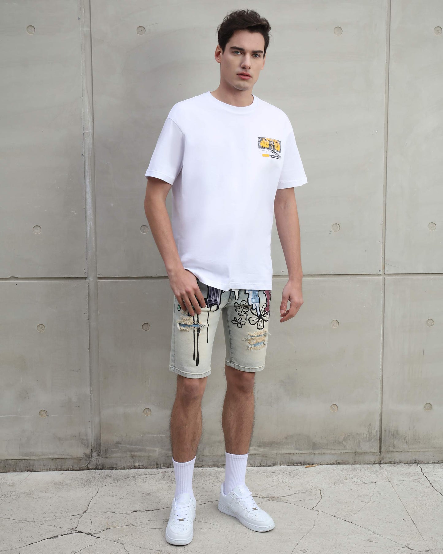 Logeqi distressed graffiti denim shorts worn by man with white t-shirt and white sneakers