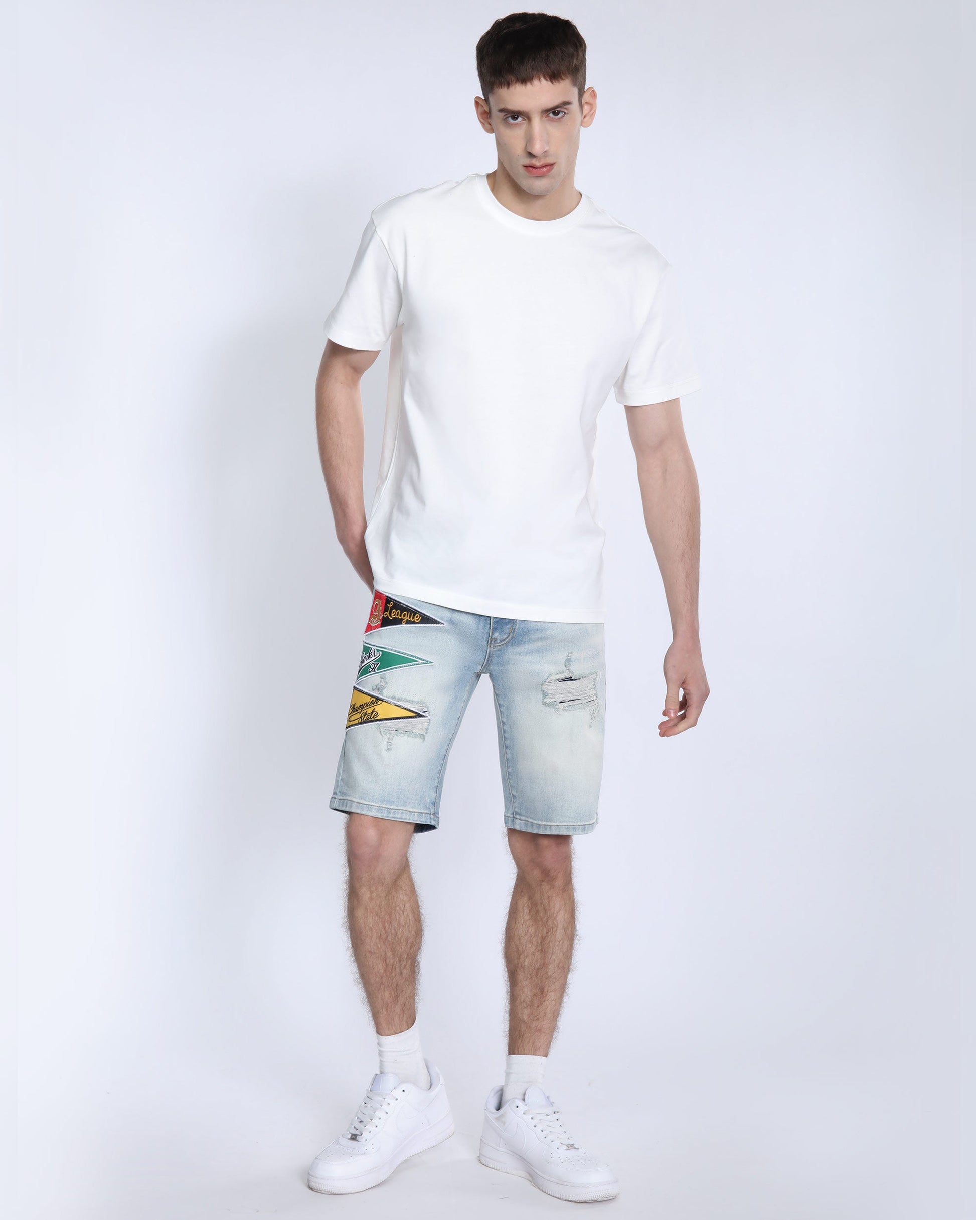 Men's light wash denim shorts by Logeqi with distressed details and colorful patches
