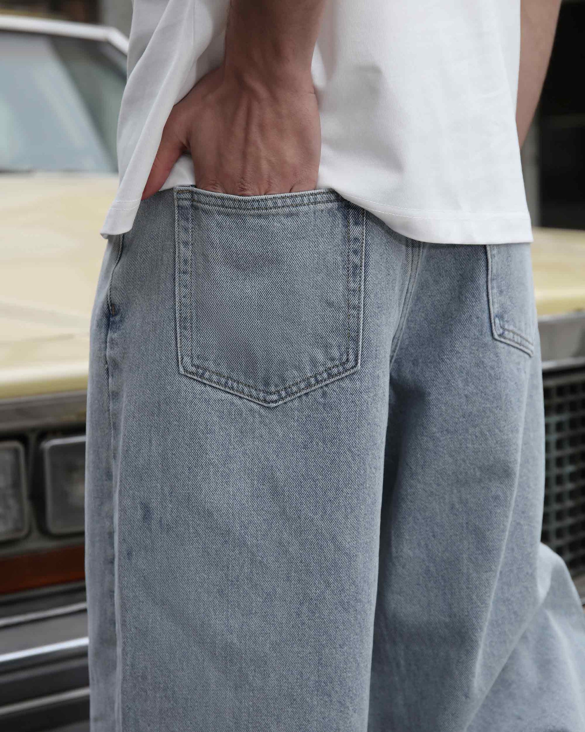Logeqi loose fit blue jeans with back pocket detail worn with a white shirt