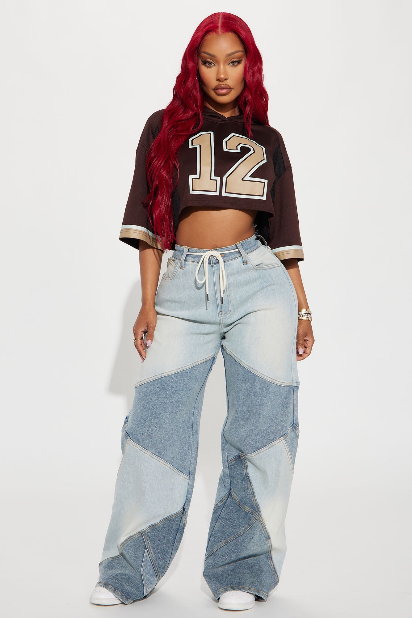 Fashion Nova brown hooded cropped jersey paired with trendy denim pants for a stylish look