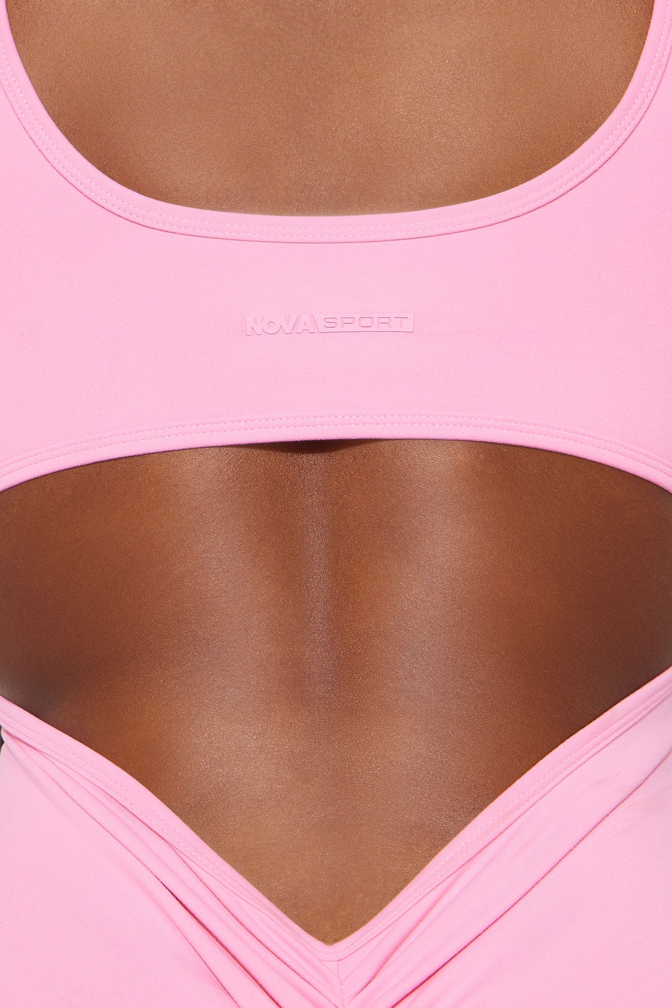 Nova Sport bubblegum pink active jumpsuit with a stylish open back design