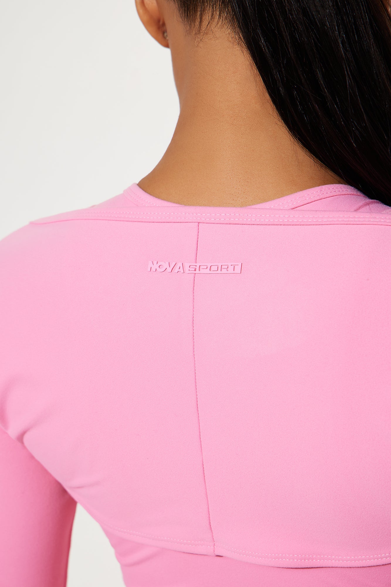 Back view of a bubblegum pink bolero dress from Nova Sport featuring a stylish design and comfortable fit