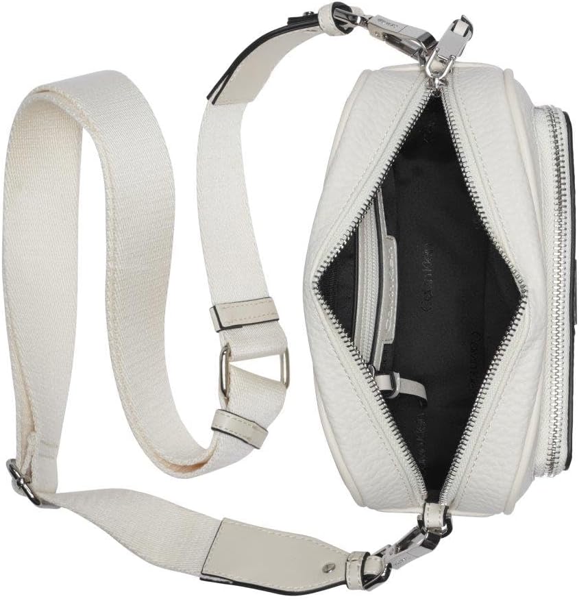 Calvin Klein camera crossbody bag in white with zipper closure and adjustable strap