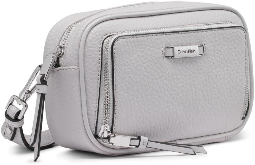 Calvin Klein camera crossbody bag in light gray with dual zipper pockets and adjustable strap