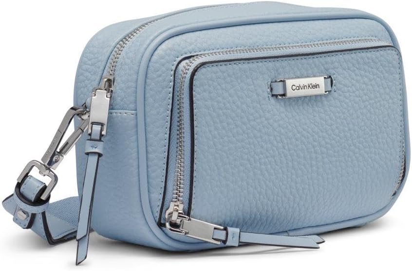 Calvin Klein camera crossbody bag in light blue with zippered compartments and adjustable strap