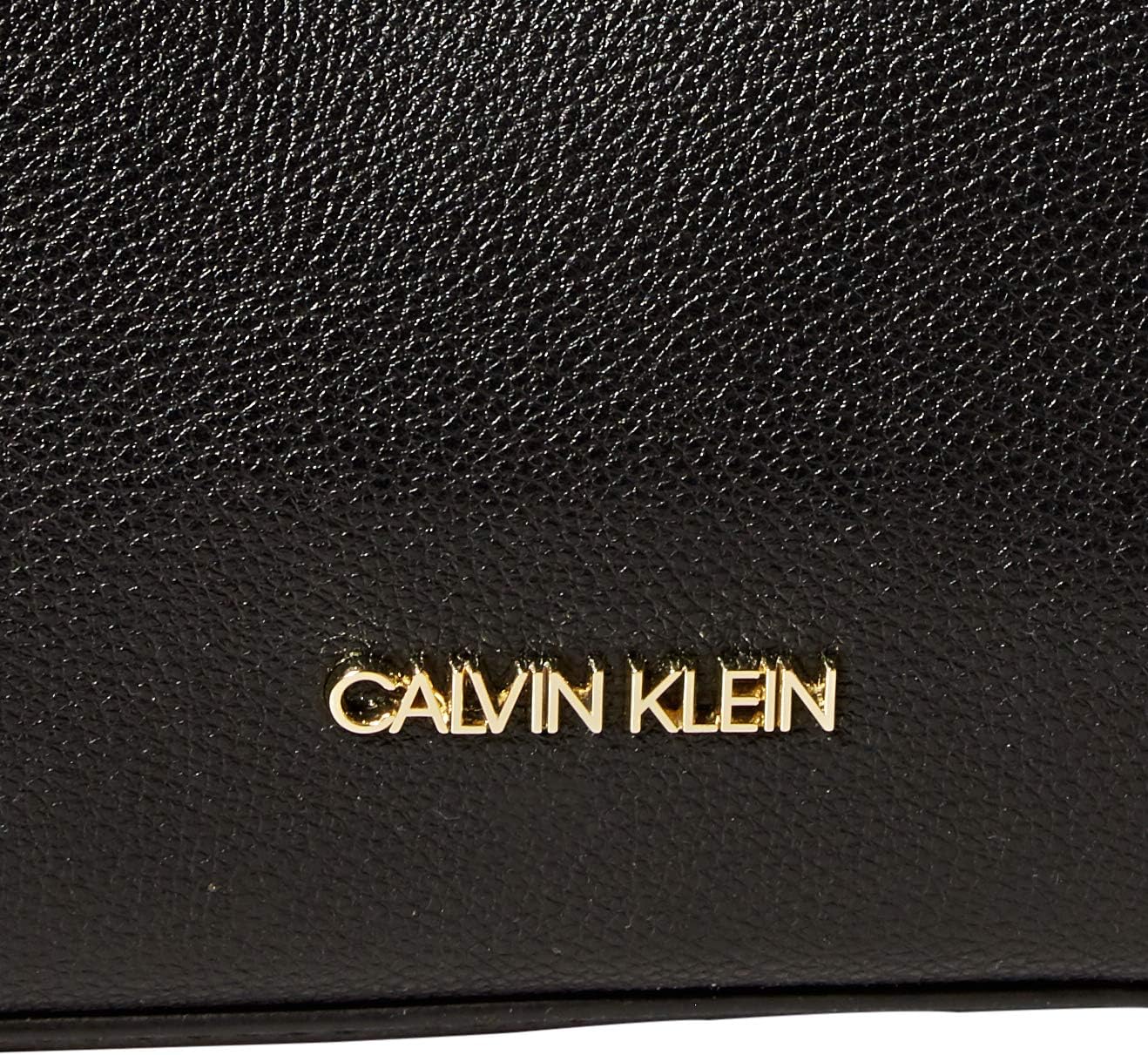 Close-up of Calvin Klein crossbody bag for women showcasing the textured black leather and gold logo