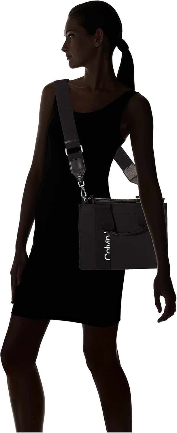 Stylish Calvin Klein crossbody bag for women showcased on a model in a black dress