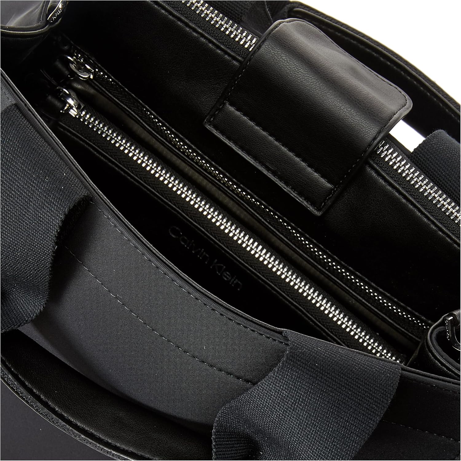 Interior view of a Calvin Klein crossbody bag for women featuring multiple pockets and premium materials