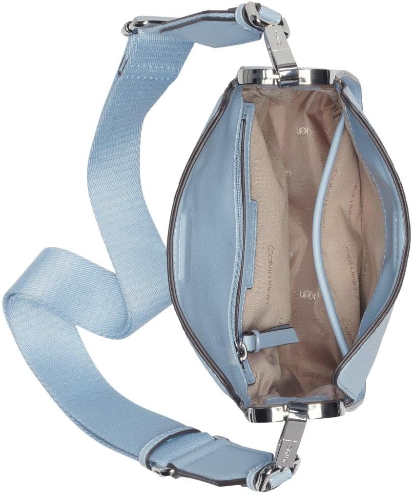 Inside view of a light blue Calvin Klein crossbody bag for women with spacious compartments and adjustable strap