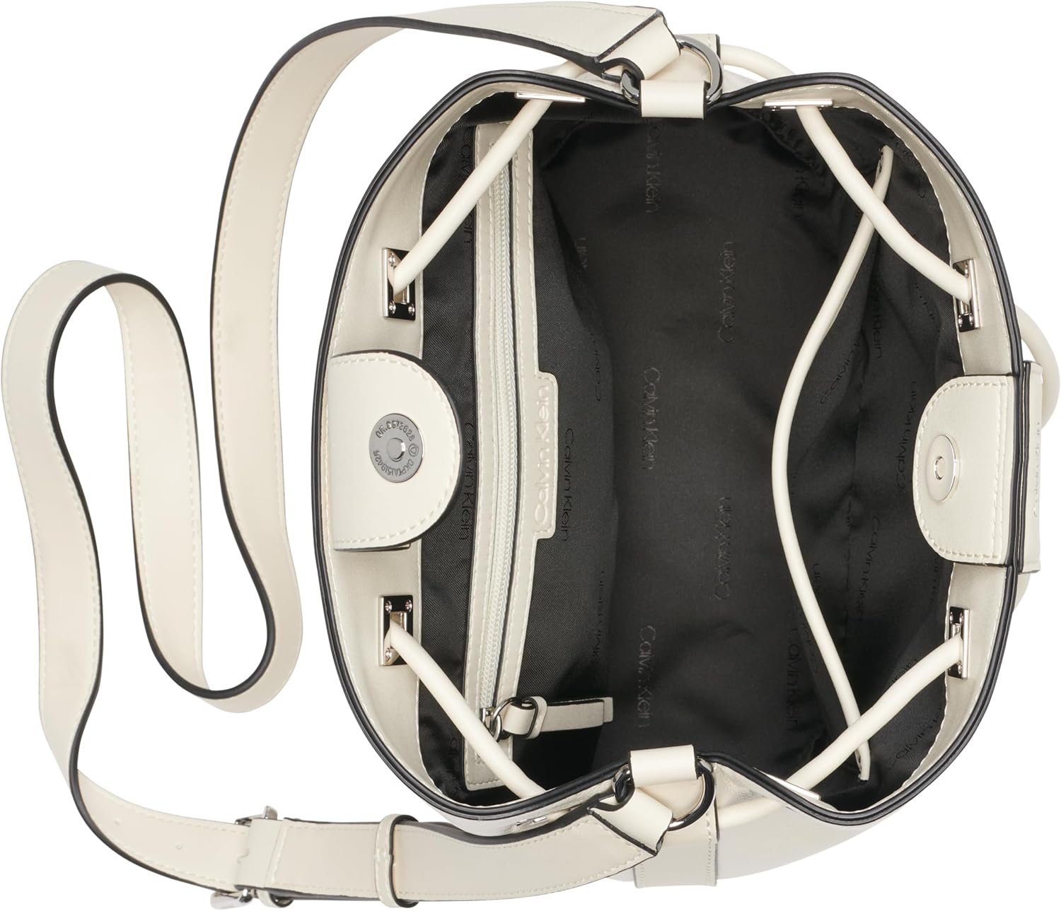 Inside view of a Calvin Klein silver bucket bag showing spacious interior and zip pocket