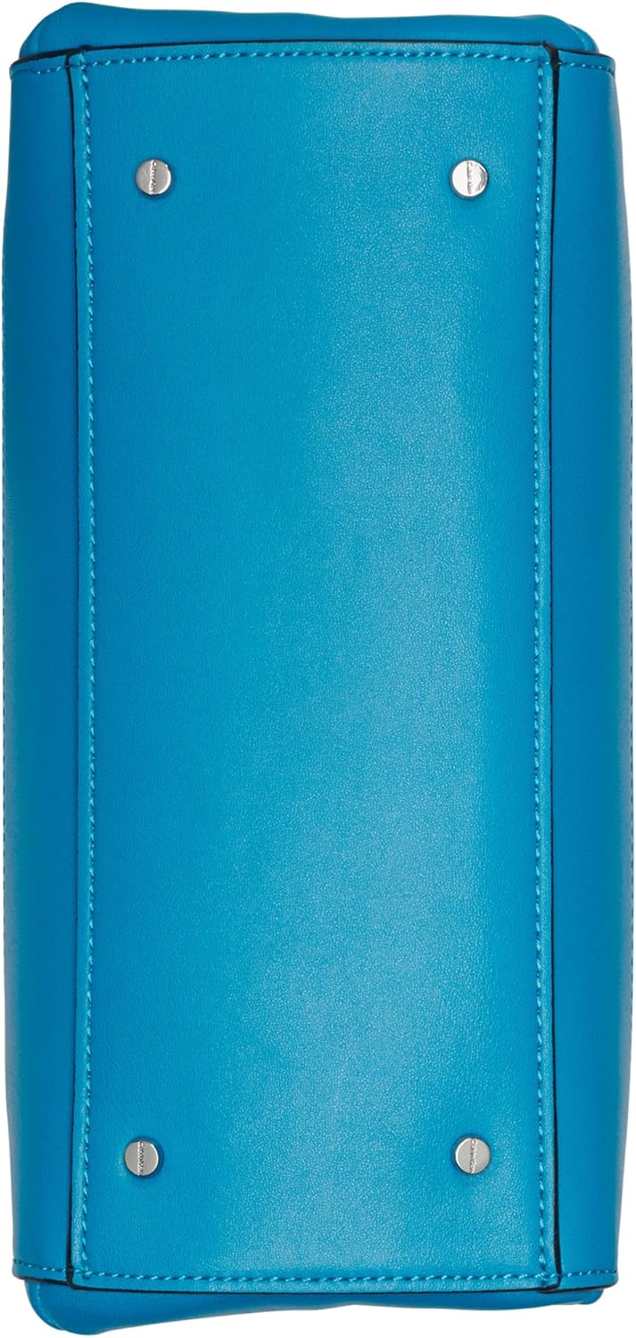 Bottom view of a Calvin Klein triple compartment crossbody bag in bright blue with protective metal studs