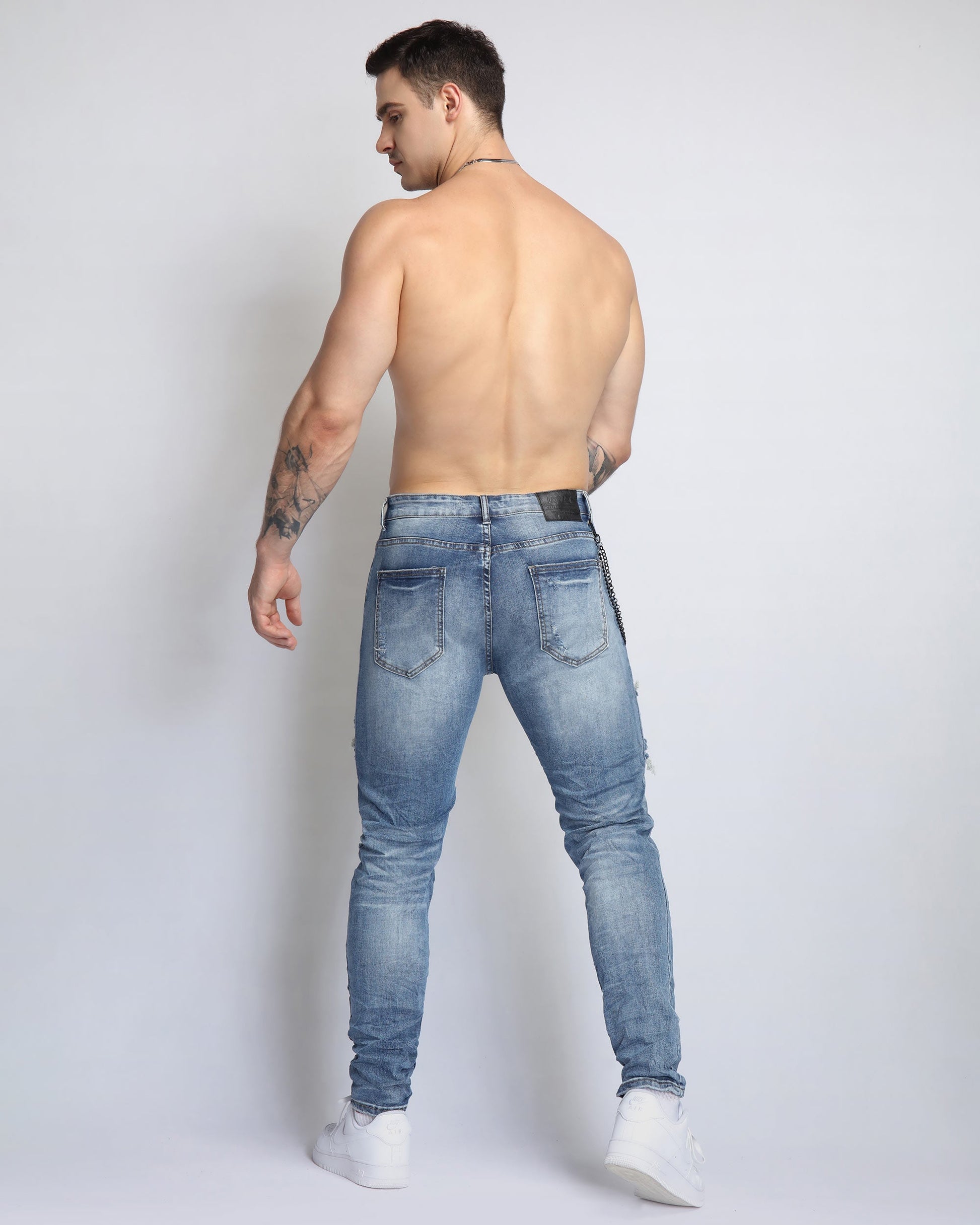 Cashew Blossom patched jeans in light blue with a slim fit and distressed detailing