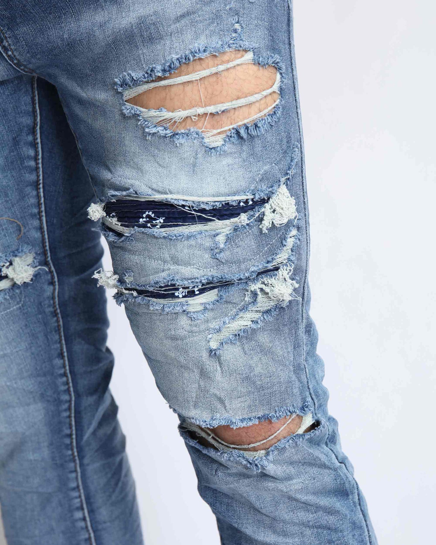 Logeqi Cashew Blossom patched jeans featuring distressed detailing and ripped accents